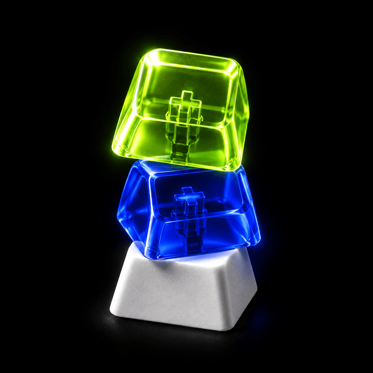A tower of three keycaps: acid green, cobalt, white